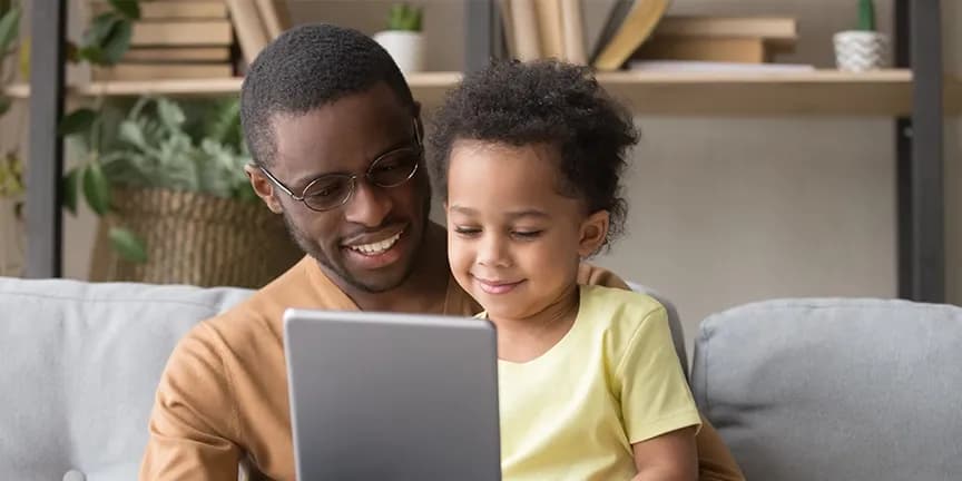 Father and daughter reading tablet